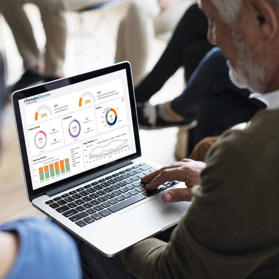 businessman with laptop reviewing a dashboard